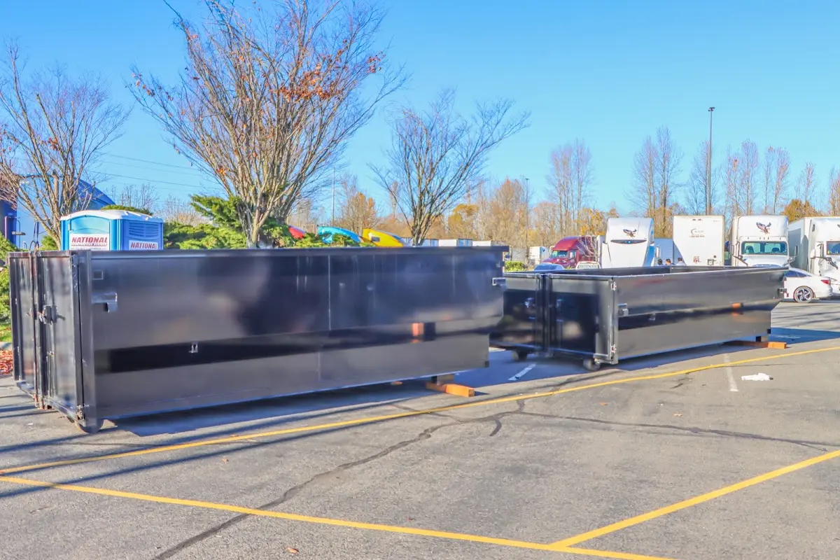 Professional dumpster rental service with roll-off container on residential driveway in Springettsbury